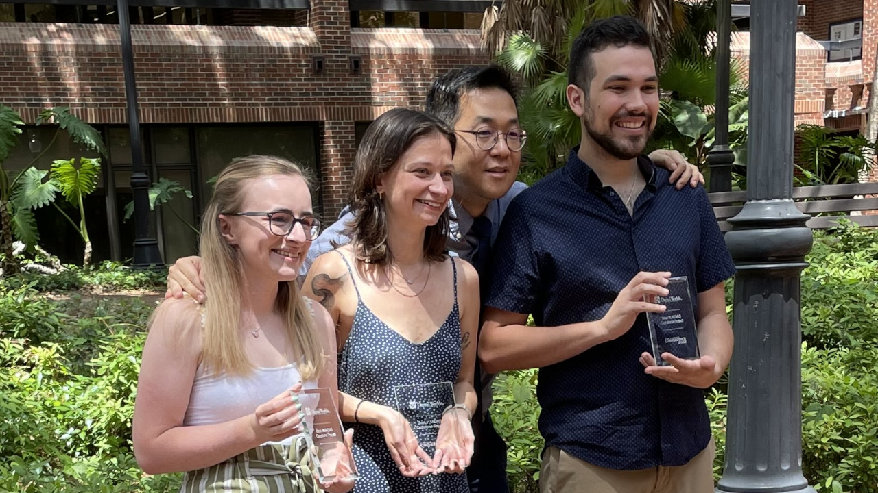 Sadie Crawford, Charlotte Atwill, Seung Hyuk Jang (professor), and Daniel Briz (left to right) holding awards for 'Best MiDAS Capstone'